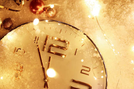Stylish Christmas clock, decor and snow on table, closeupの写真素材