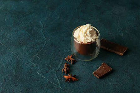 Glass of natural hot chocolate on black background