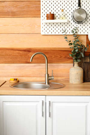 Counter with sink and vase near wooden wallの写真素材
