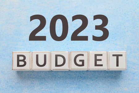 Word BUDGET made of cubes and figure 2023 on light blue backgroundの写真素材