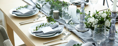 Beautiful festive table setting with floral decor and candlesの写真素材