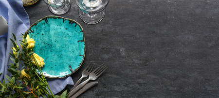 Beautiful table setting with floral decor on dark background with space for textの写真素材