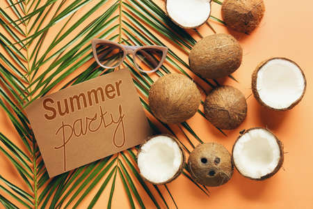 Advertisement banner for summer party with tropical leaf, coconuts and sunglassesの写真素材