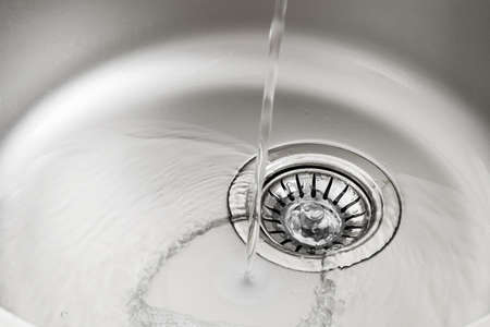Water pouring into sink, closeup