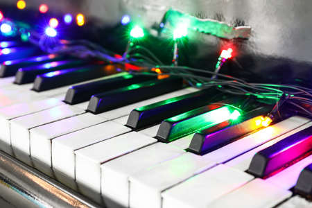Glowing colorful lights on piano, closeup