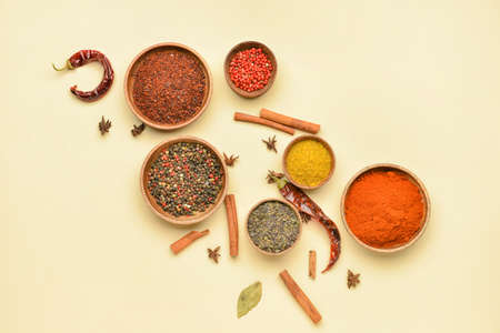 Bowls with aromatic spices on yellow backgroundの写真素材