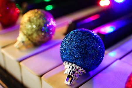 Shiny Christmas ball on piano keys, closeupの写真素材