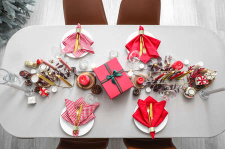 Festive table setting for Christmas celebration in roomの写真素材