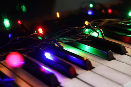 Glowing colorful lights on piano, closeupの写真素材