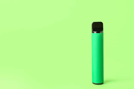 Disposable electronic cigarette on green backgroundの写真素材