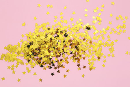 golden confetti on pink background