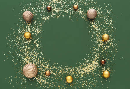 Frame made of golden confetti and Christmas balls on green background