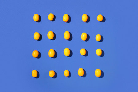 Tasty kumquat fruits on blue backgroundの写真素材