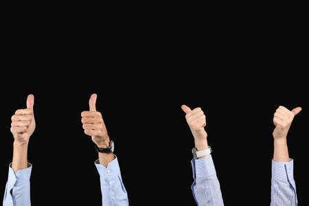 Business colleagues showing thumbs-up on black background