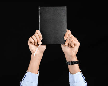 businessman with notebook on black backgroundの写真素材