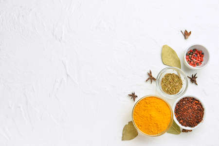 Bowls of aromatic spices on light background