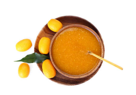 Bowl of tasty kumquat jam and fresh fruits on white background