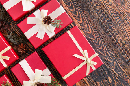Beautiful composition with Christmas gift boxes on wooden background