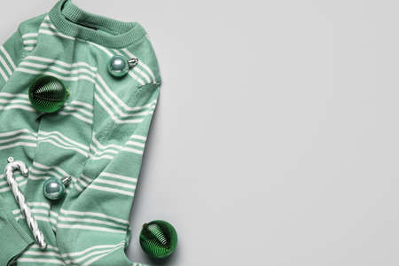 Warm sweater and Christmas decor on gray backgroundの写真素材