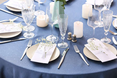 Stylish table setting with wedding invitations and gypsophila flowersの写真素材