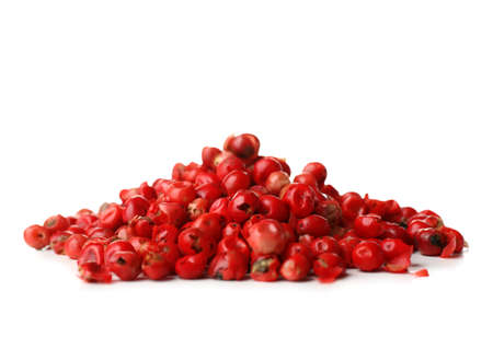 Heap of red peppercorns on white background