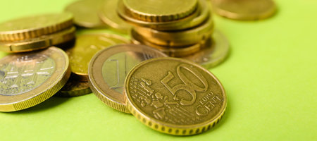 Many coins on color background, close up