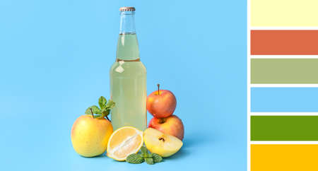 Bottle of tasty soda and fresh fruits on blue background. different color patterns