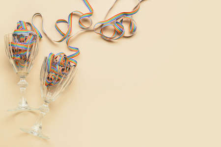 Glasses with rainbow ribbons on color background. LGBT conceptの写真素材