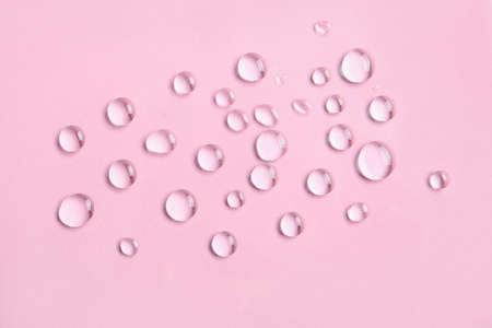 Many water drops on pink backgroundの写真素材