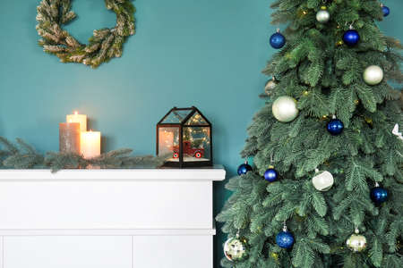 Fireplace with beautiful decorations and Christmas tree in living room