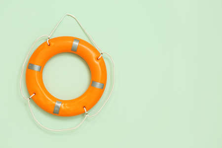 Ring buoy hanging on green wall