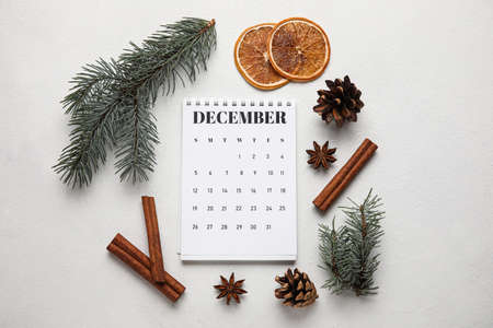 Calendar with date of winter solstice and decorations on white background
