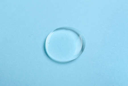 Drop of liquid transparent gel on blue backgroundの写真素材