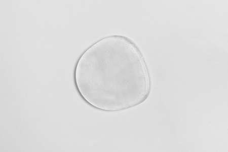 Drop of liquid transparent gel on white background