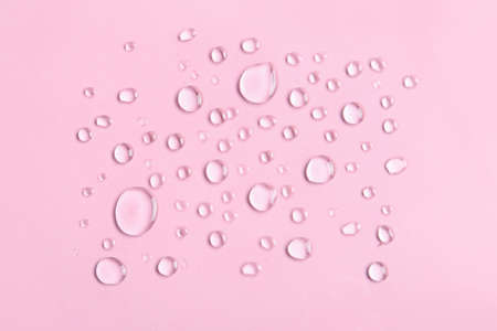 water drops on pink backgroundの写真素材
