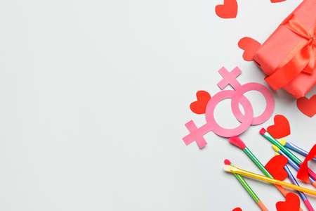 Gift with symbols of woman and colorful brushes on light background. LGBT conceptの写真素材