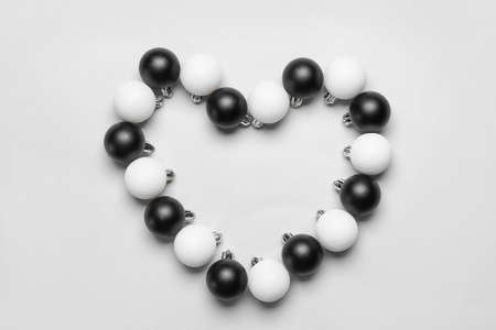Heart made of beautiful Christmas balls on white backgroundの写真素材
