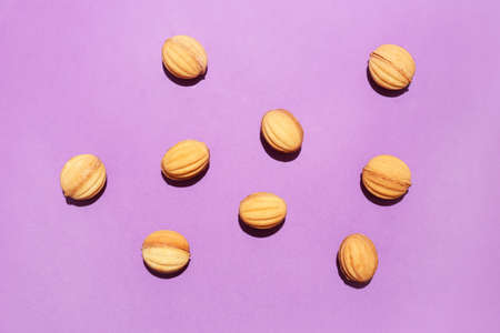 Tasty walnut shaped cookies with boiled condensed milk on color backgroundの写真素材