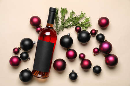 Composition with bottle of wine, Christmas balls and fir branch on color backgroundの写真素材