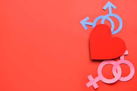 Paper heart with symbols of woman and man on color background LGBT concept