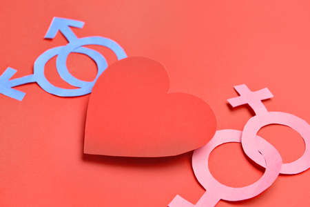 Paper heart with symbols of woman and man on color background LGBT conceptの写真素材
