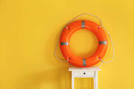Ring buoy on table near yellow wallの写真素材