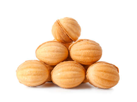 Heap of tasty walnut shaped cookies with boiled condensed milk isolated on white background