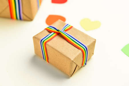 Gift with rainbow ribbon on light background. LGBT concept