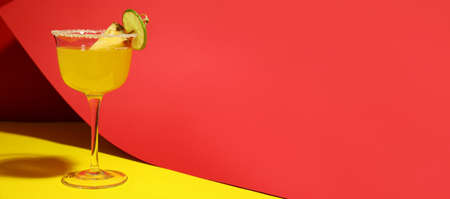 Glass of pineapple daiquiri cocktail on color background with space for textの写真素材