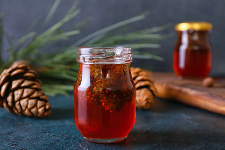 Jar of tasty pine cone jam on dark background, closeupの写真素材
