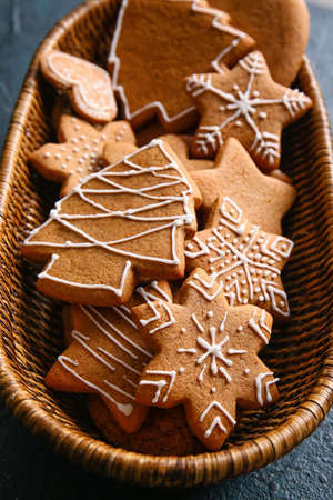 Basket with sweet Christmas gingerbread cookies on black backgroundの写真素材