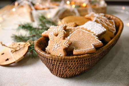 Basket with sweet Christmas gingerbread cookies on tableの写真素材