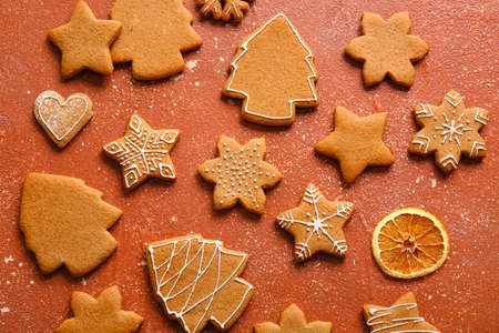 Sweet Christmas gingerbread cookies on red background