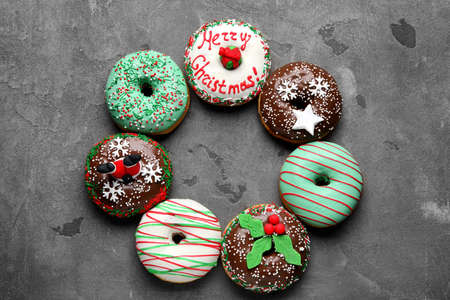 Frame made with tasty Christmas donuts on gray backgroundの写真素材